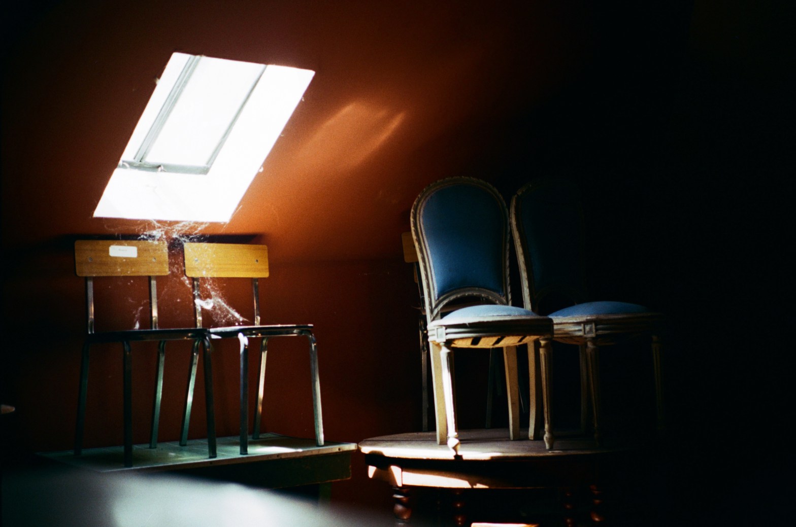 Two sets of four chairs left in the dusty attic