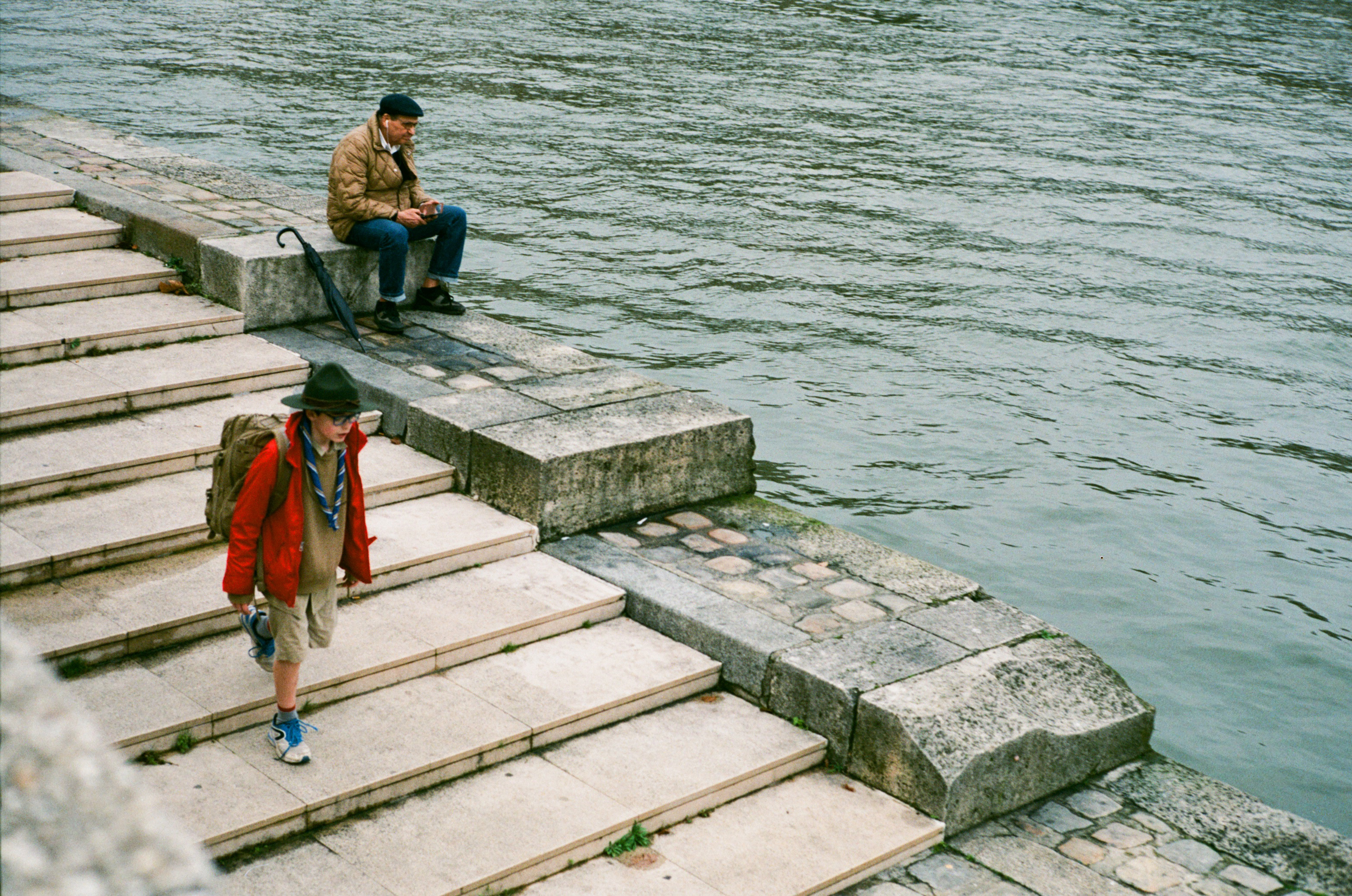 Dressed up young scout walking down stairs Seine left bank